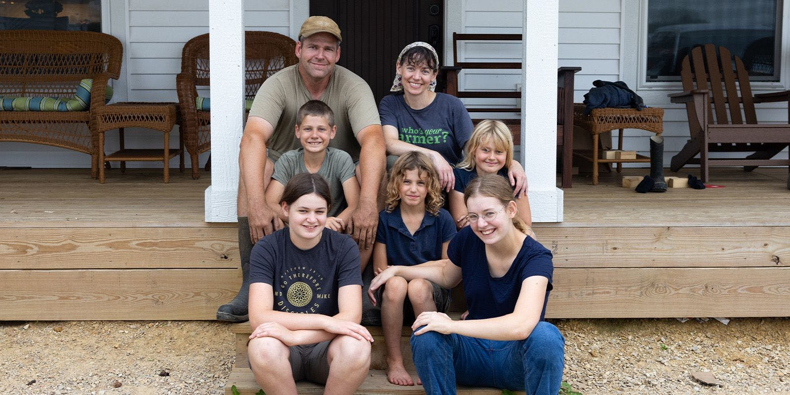 Seven members of the Canter family sit on the steps of their Wisconsin home.