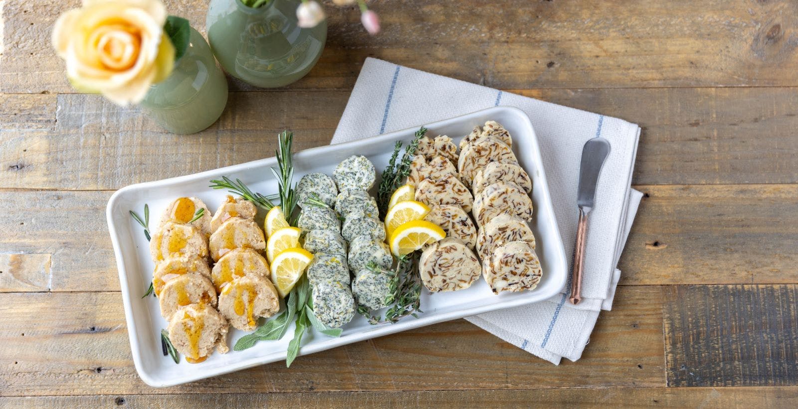 Four varieties of compound butters served on a tray.