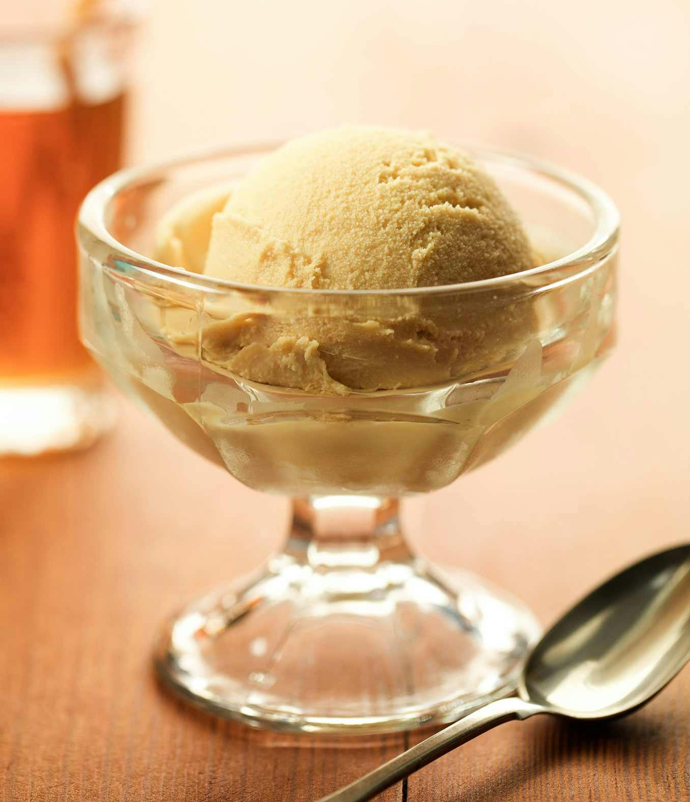 Real-Deal Maple Ice cream in a ice cream dish with a spoon on the side.