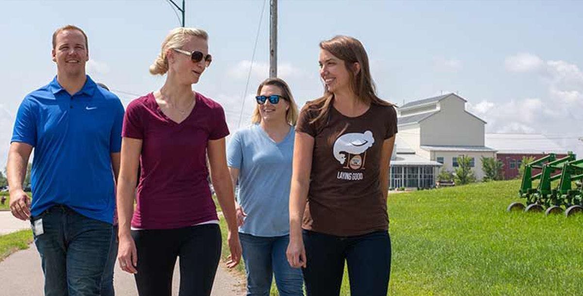 Four people who work at Organic Valley outside for an afternoon walk.