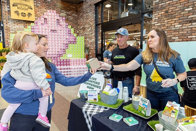 Organic Valley farmer and employee handing out samples in a Whole Foods Market.