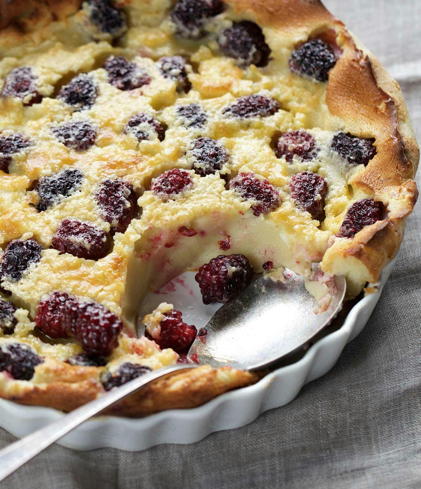 Blackberry Clafoutis with a spoon-full missing