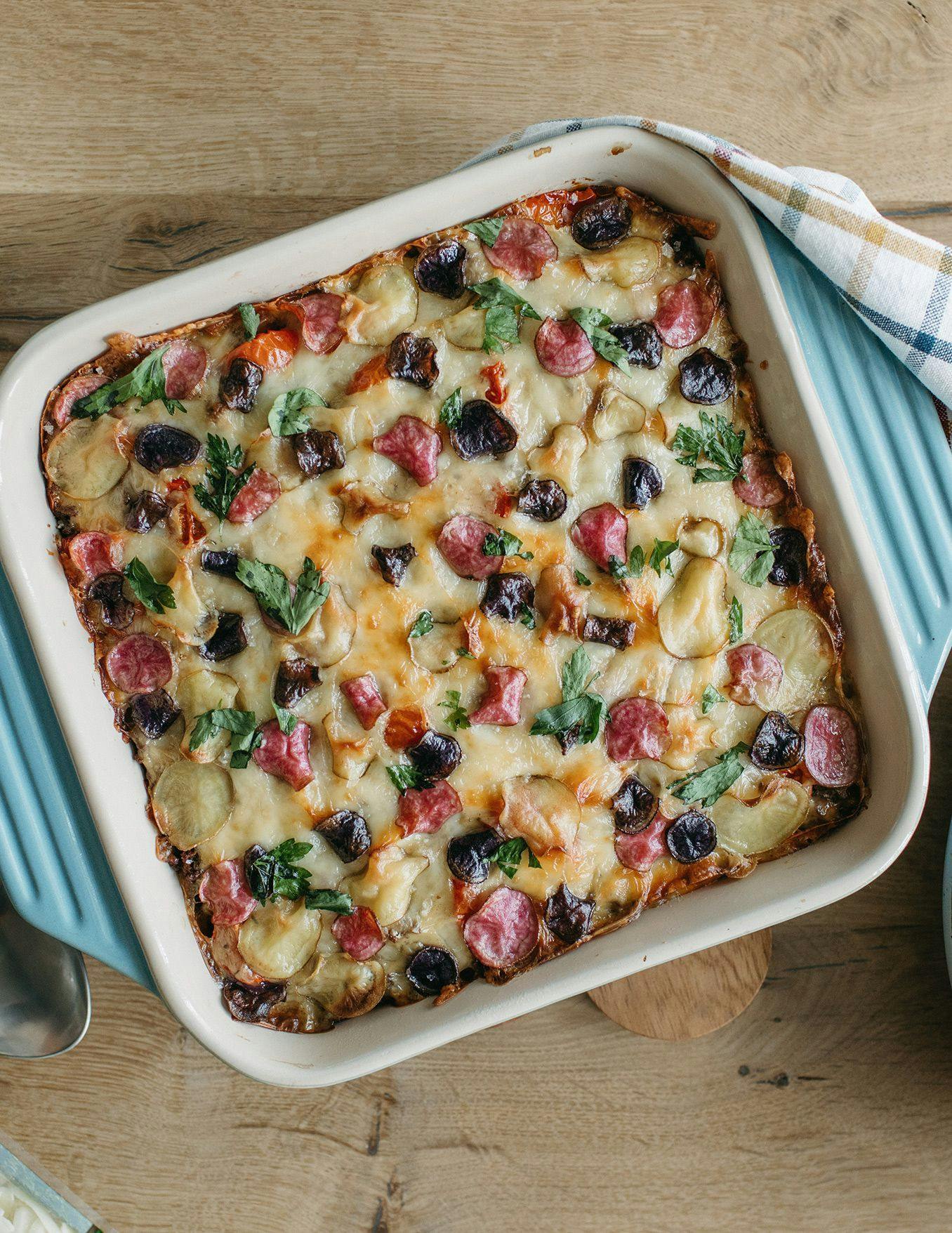 Cheesy Garden hotdish with vegetables sitting on a table. 