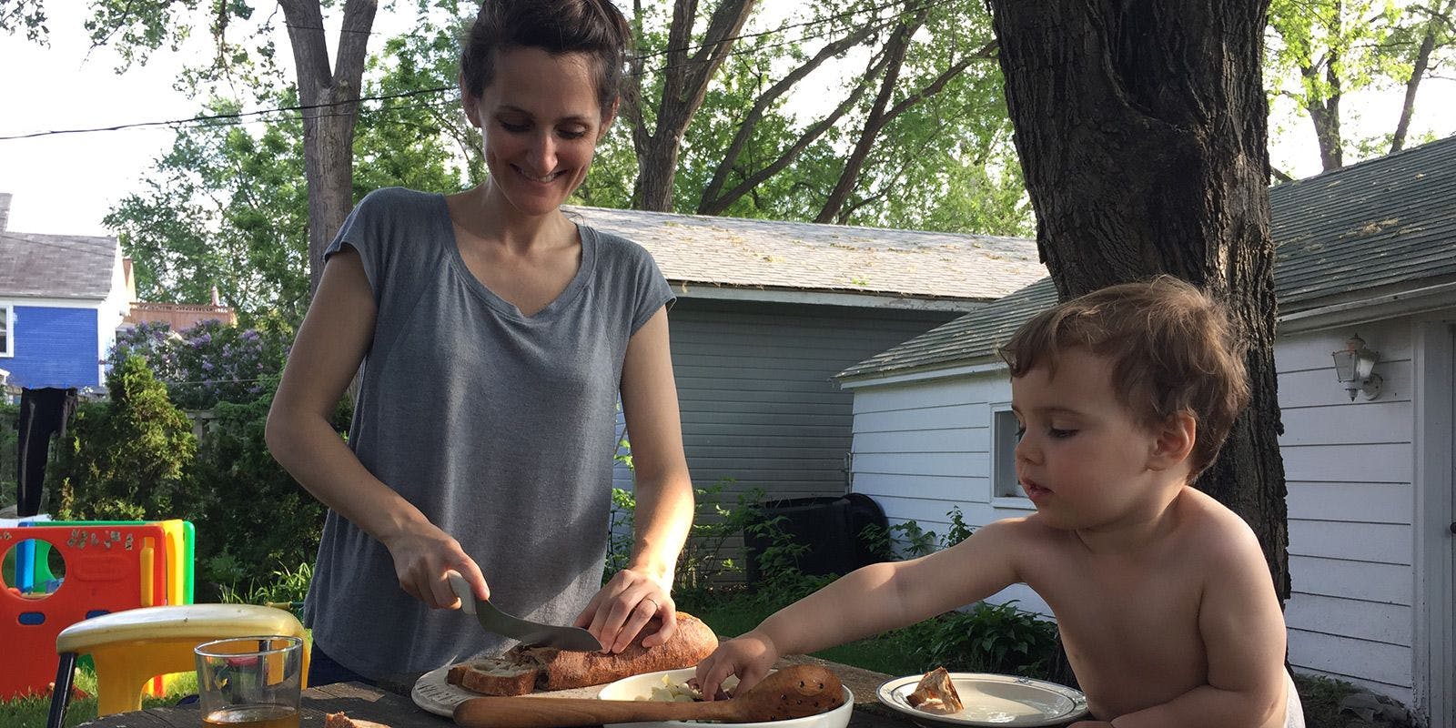 Mom serves dinner on a picnic table in the backyard. Photo by The Perennial Plate.