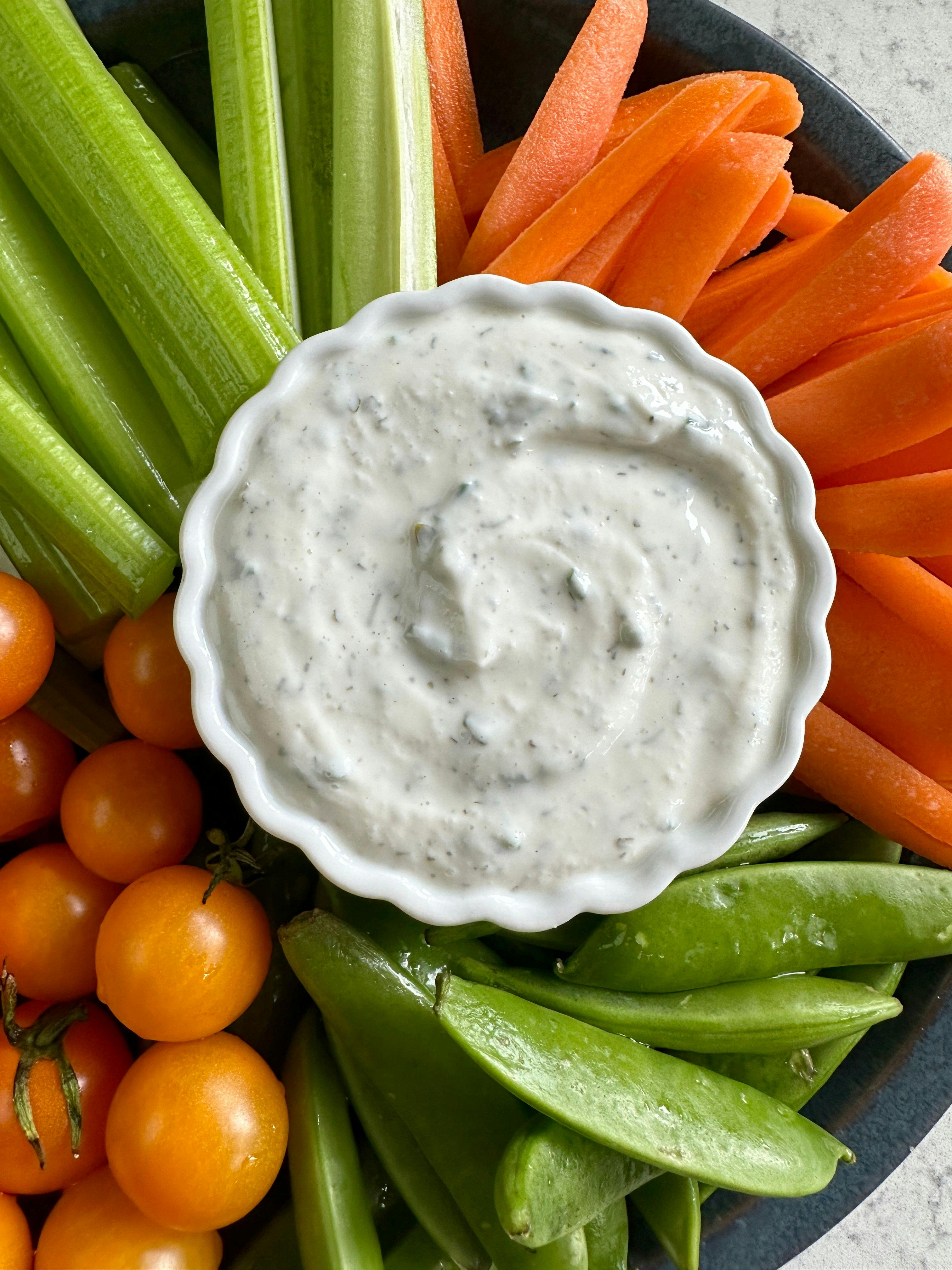 Cottage Cheese Ranch Dip in a small bowl surrounded by a variety of vegetables.