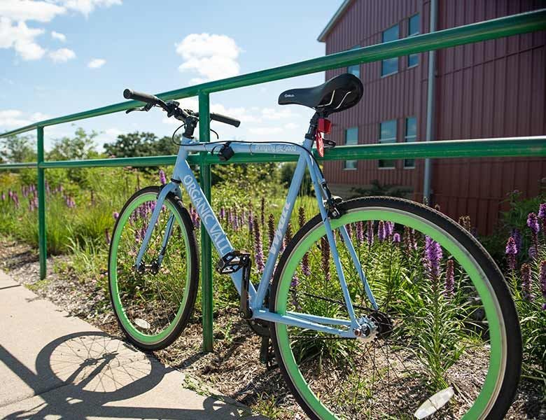 A bike resting on a fence at the Organic Valley headquarters building.