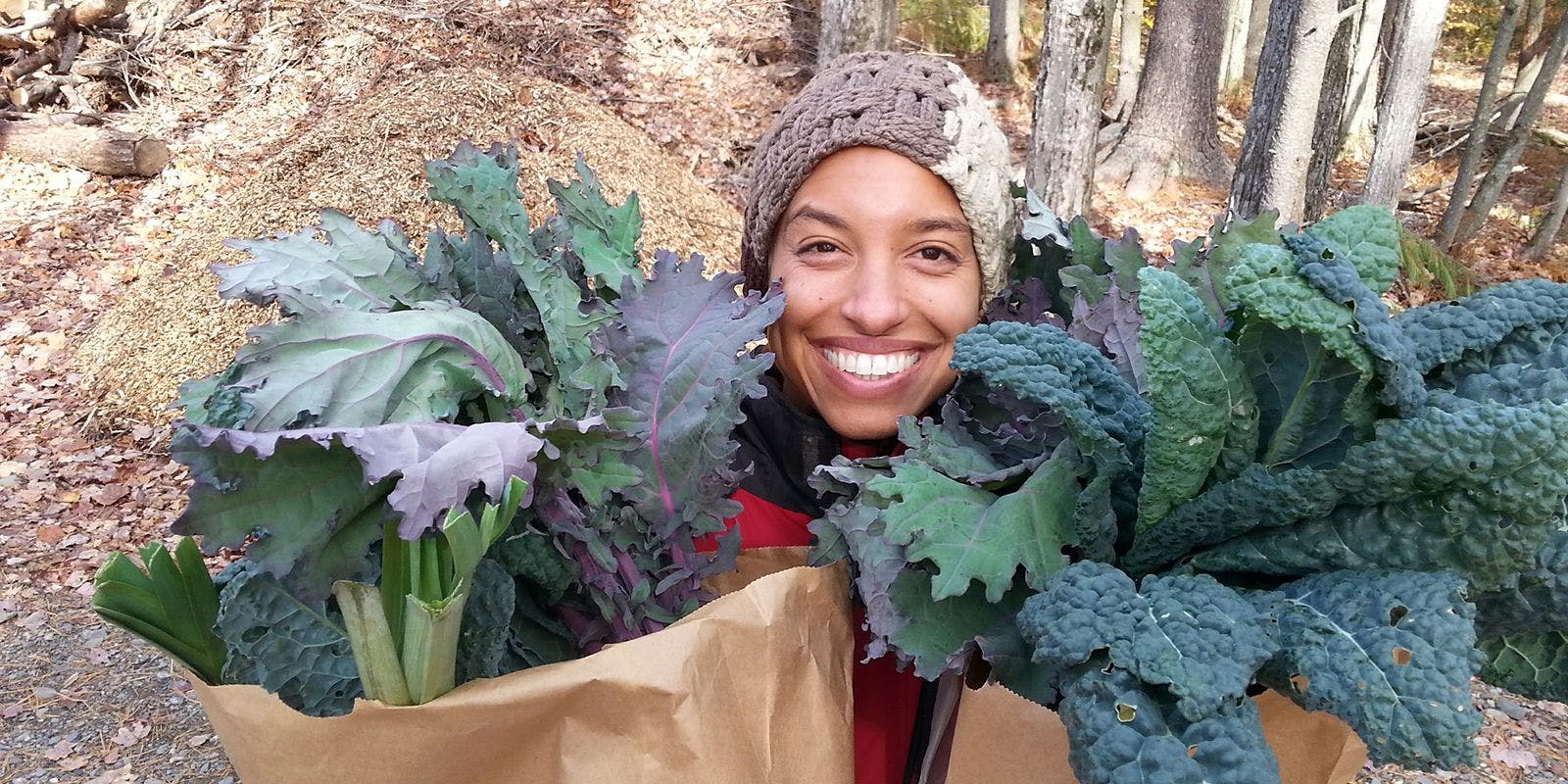 Leah Penniman holding bunch of produce.