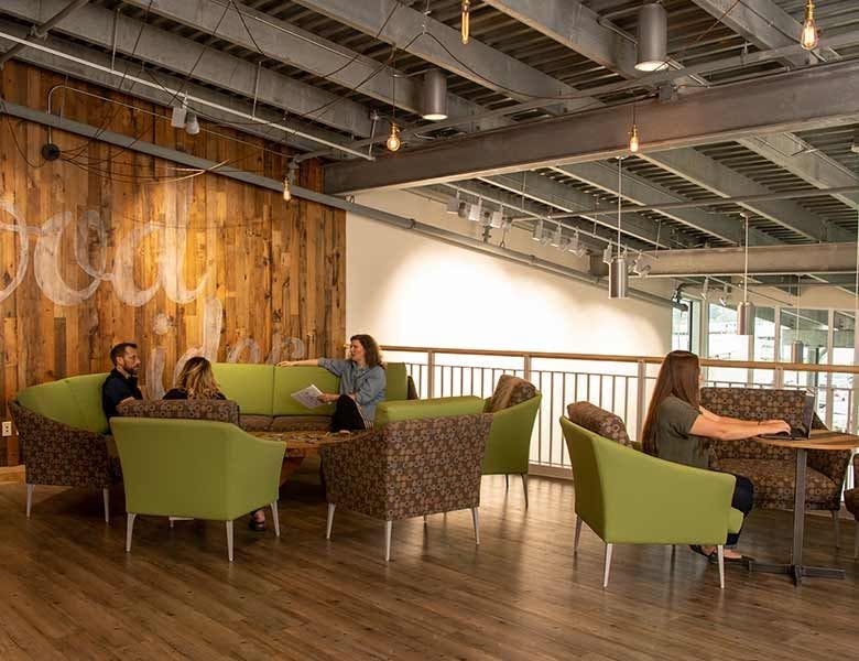 Several people who work at Organic Valley sitting in a common gathering space.