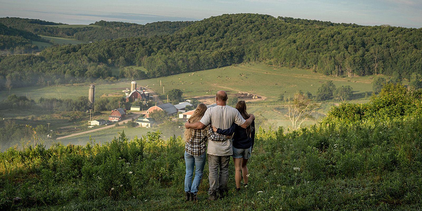 The Painters, Organic Valley farmer-members, look at their farm from a ridgetop.